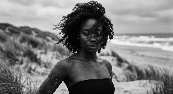 Image 1 - Woman on a windswept dune
